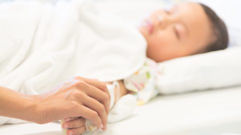 Young boy sleep and sickness stay in hospital - selective focus point