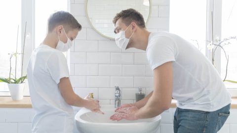 father-and-son-washing-their-hands-medium-shot